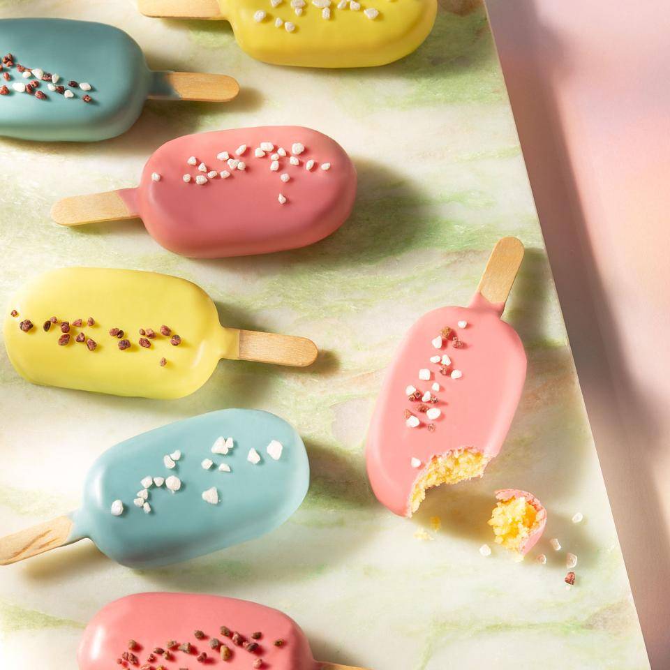 Cake pops coated in colored chocolate and decorated with sprinkles